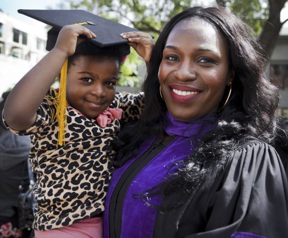 McGeorge graduate holding child