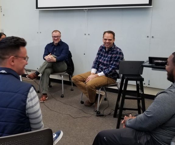 teacher speaking with students