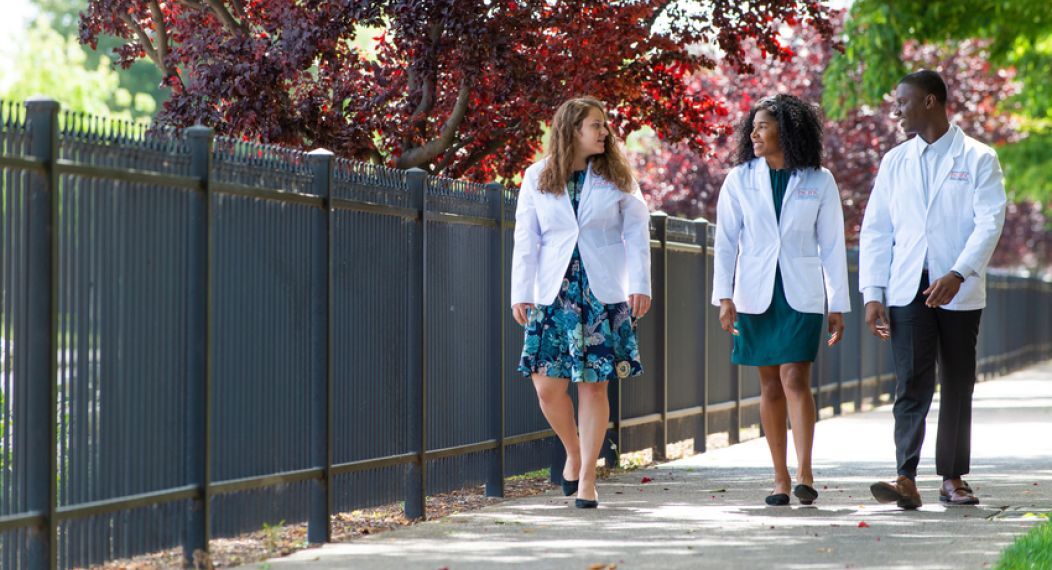 Health Sciences students in white coats on University of the Pacific's campus in Stockton, California.