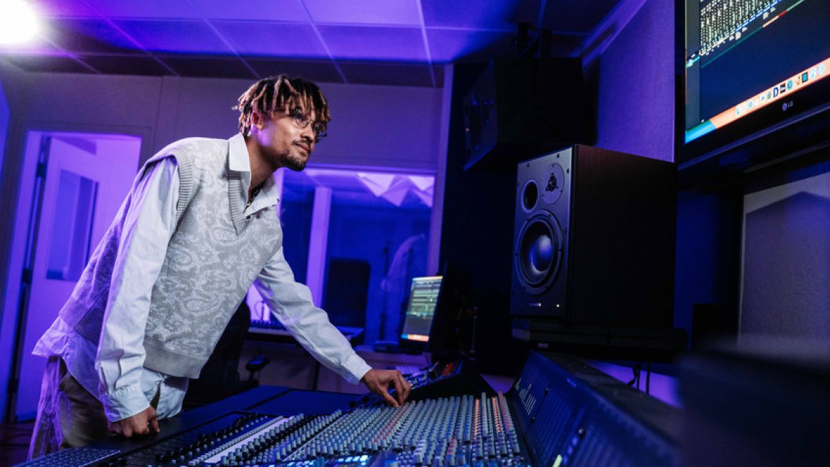 Music industry studies major working with a mixing board in University of the Pacific's recording studio