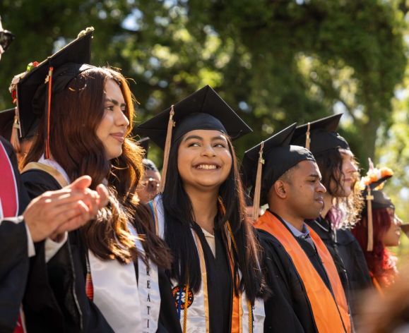 a group of Pacific students in graduation attire